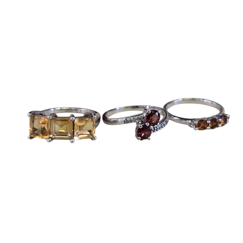 30 - A collection of 925 silver gem-set rings,comprising a three-stone citrine ring, size R½; a two-stone... 