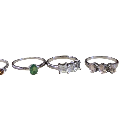 30 - A collection of 925 silver gem-set rings,comprising a three-stone citrine ring, size R½; a two-stone... 