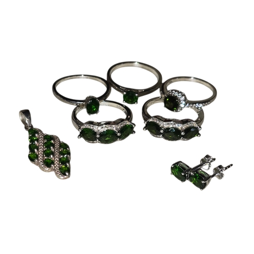 31 - A collection of sterling silver and chrome diopside jewellery, comprising two three-stone rings with... 