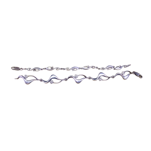 34 - A collection of silver and costume jewellery,comprising two 925 silver bracelets of flowing abstract... 