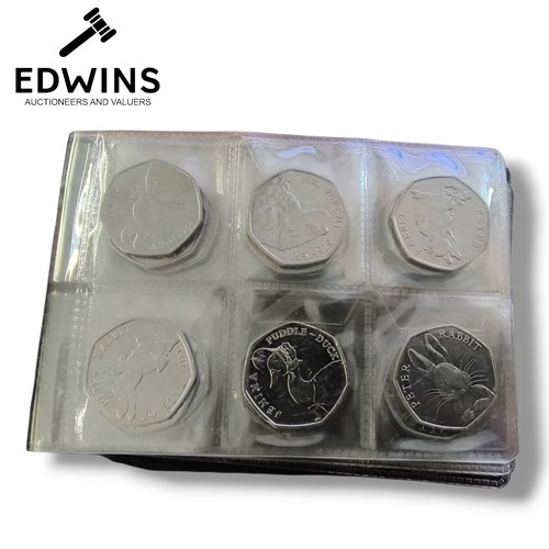 53 - An Album of Commerative 50p coins and one 20p coin, total cash value £21.20.  Includes Jemima Puddle... 