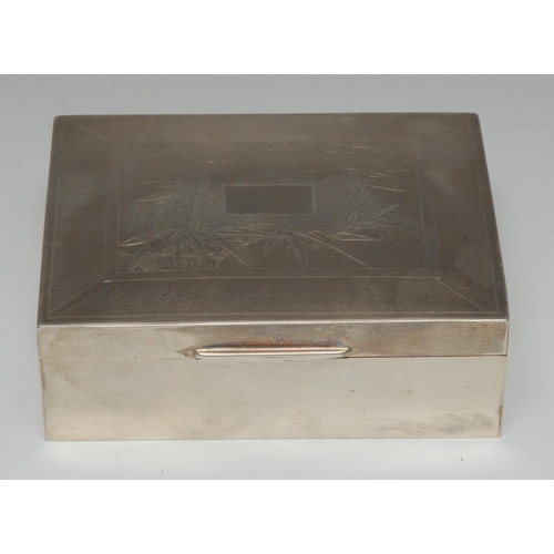 1001 - A Chinese silver rectangular table cigarette box, hinged cover engraved with leafy bamboo centred by... 