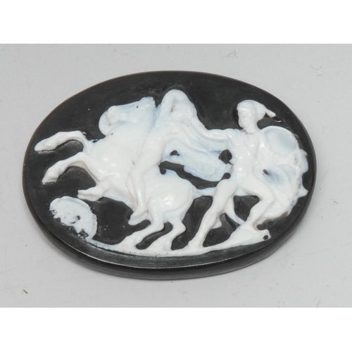 1133 - A carved black and white oval cameo panel, Neoclassical Warriors and rearing Horse, 43mm x 58mm