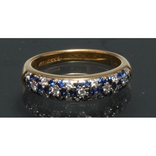 1141 - A sapphire and diamond eternity ring, the top crest inset with a checkered panel of thirty nine mixe... 