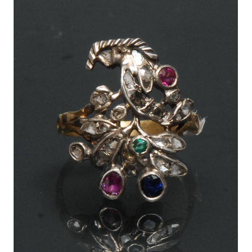 1143 - A multi gem diamond, emerald, sapphire and ruby floral finger ring, open floral crest inset with twe... 