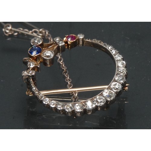 1144 - An Edwardian diamond sapphire and ruby floral crescent brooch, the crescent inset with twenty one ol... 