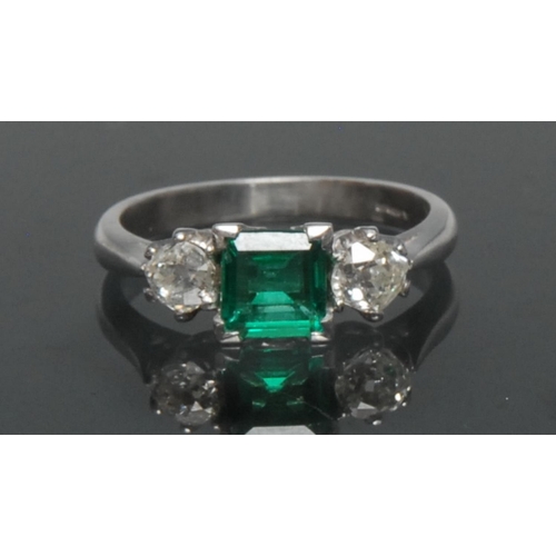 1149 - A Columbian emerald and diamond trilogy ring, central square cushion cut vibrant green emerald, appr... 