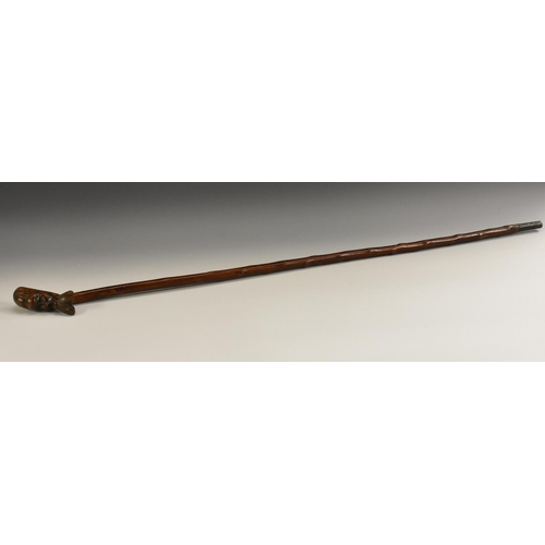 1942 - Folk Art - a 19th century novelty hedgerow walking stick, boldly carved with the head of a stylized ... 