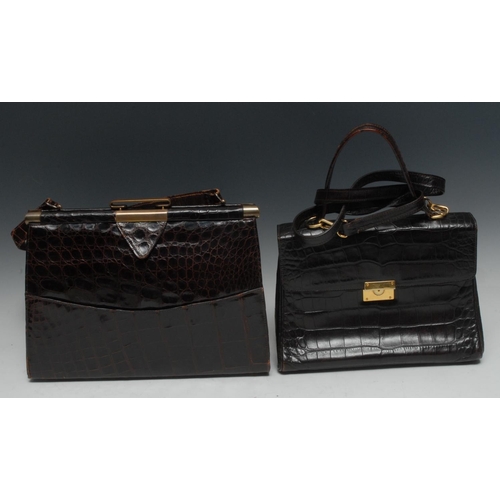 1958A - Luxury Fashion - a lady's brown crocodile lady's handbag, brass clasps, 32cm wide; another, similar,... 