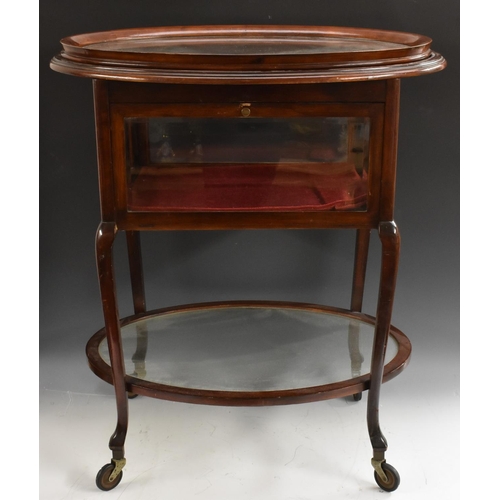 1999 - An unusual Edwardian mahogany drinks waiter's trolley, the oval top with lift-off serving tray, abov... 