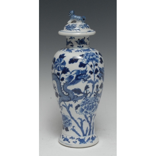 391 - A Chinese porcelain baluster vase and cover, painted in underglaze blue with ferocious dragons and p... 