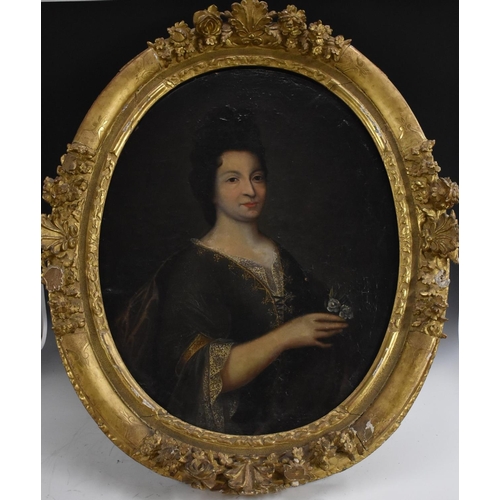 530 - French School (c.1680) Portrait of a Lady, half length, holding a flower posy oil on canvas, oval, 8... 