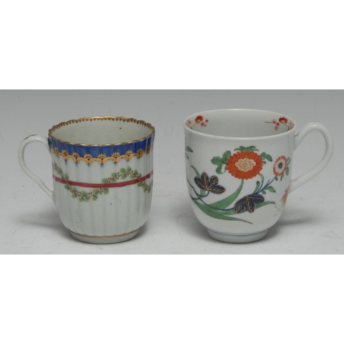 78 - A Worcester ribbed coffee cup,  painted with green leaf and red berried swags entwined in a crimson ... 