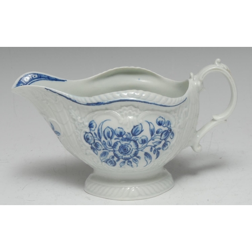 84 - A Worcester blue and white sauce boat, crisply moulded with overlapping scales painted with flowers ... 