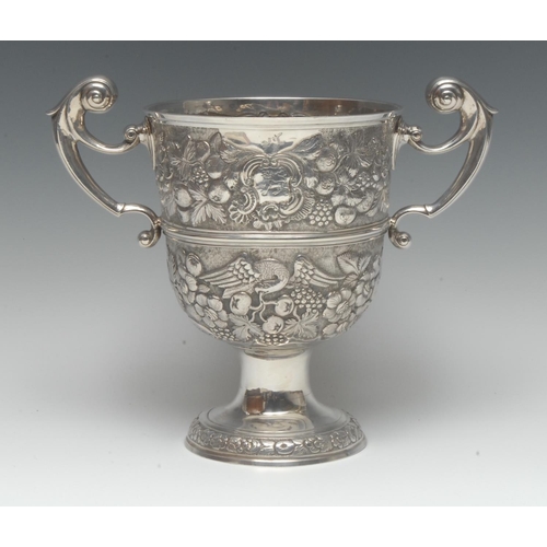 907 - A large George II Irish silver two-handled pedestal loving cup, chased with eagles and fruiting foli... 