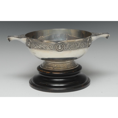 911 - A large Arts and Crafts silver presentation quaich, in the Celtic taste with borders of knotted moti... 