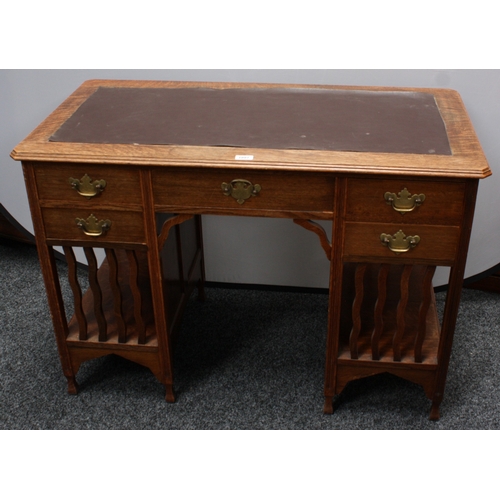 1991 - An Arts and Crafts oak rectangular desk, in the manner of Liberty & Co, canted oversailing top with ... 