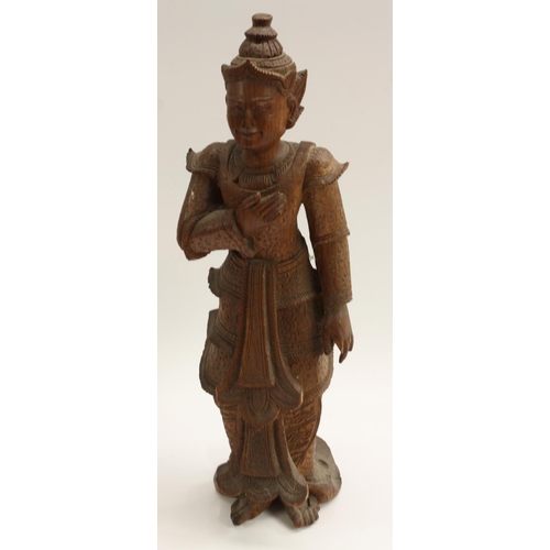 3103 - A Burmese hardwood figure, carved as a deity, 49cm high, early 20th century; an Indian panel, carved... 