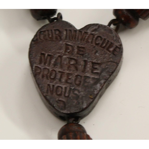 3244 - A set of French hardwood rosary beads, the heart shaped pendant stamped Souvenir de nd de Lourdes, 1... 