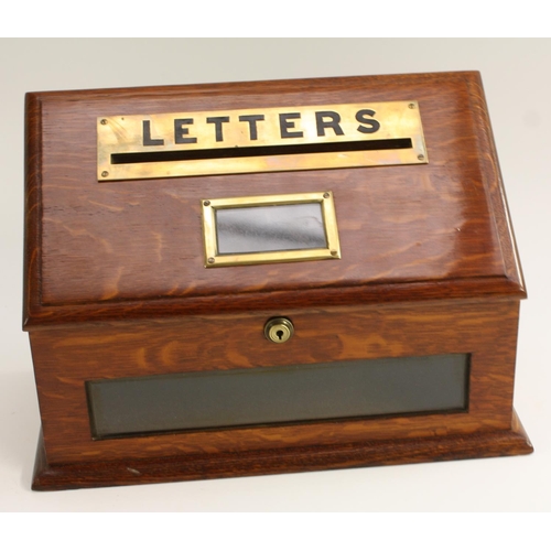 3261 - A Victorian oak country house post box, the well figured hinged sloping cover with labelled letter s... 