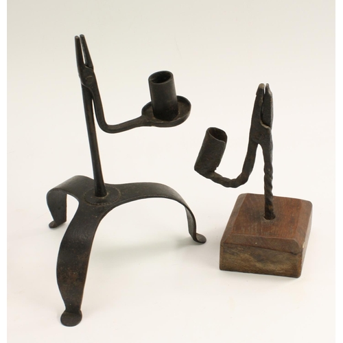 3264 - A wrought iron nip rushlight holder, with candle socket, square oak base, 20cm high; another, tripod... 