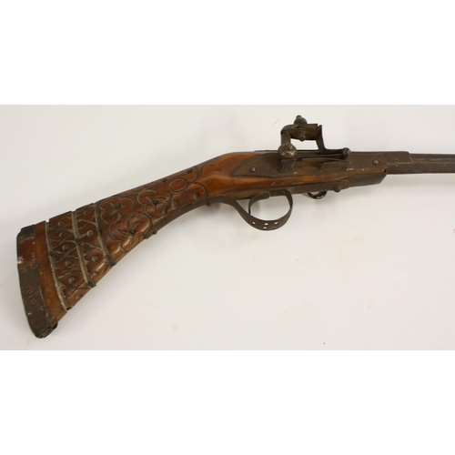 3301 - An early 20th century child's toy model, of a flintlock rifle, 64cm barrel with steel ramrod, carved... 