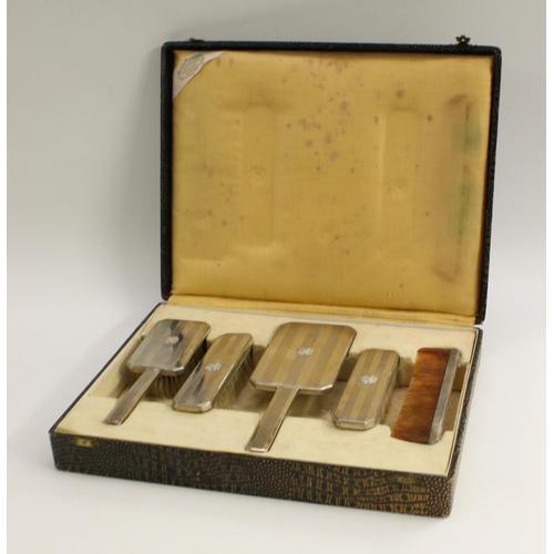 3400 - Nazi Germany and The Third Reich - a German silver five piece dressing table set, comprising hand mi... 