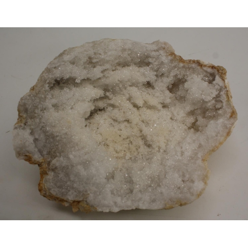 3509 - Geology - a bisected white quartz geode, cut to display matrix, 15cm wide