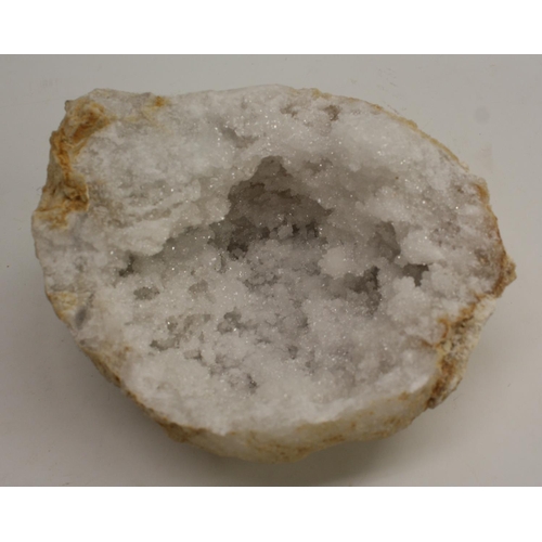 3509 - Geology - a bisected white quartz geode, cut to display matrix, 15cm wide