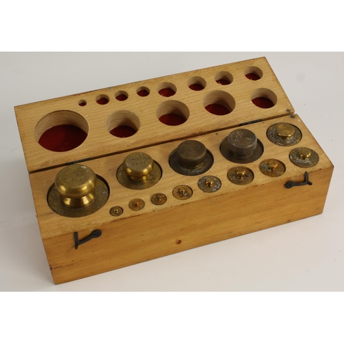 3577 - A set of thirteen brass scientific balance/scale weights, 1 Kilo to 9m, fitted beech cas, 25.5cm wid... 