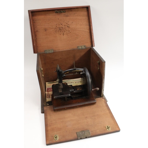 3006 - A 19th century  Hopkinson & Bros, Doncaster  black and gilt metal sewing machine, mahogany base,. 23... 