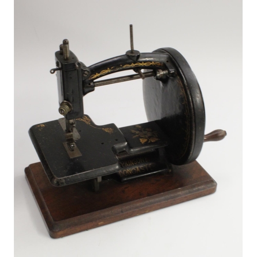 3006 - A 19th century  Hopkinson & Bros, Doncaster  black and gilt metal sewing machine, mahogany base,. 23... 