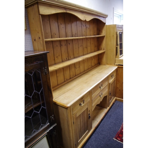 486 - A country kitchen pine dresser, outswept cornice, shaped frieze and shelving to top, oversailing top... 