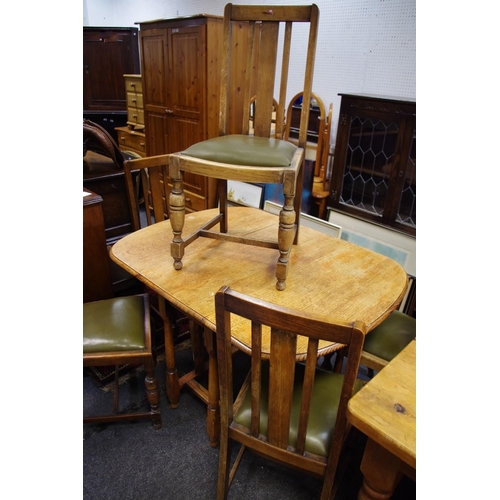 502 - An early 20th century oak gateleg dining table; five oak dining chairs (6)