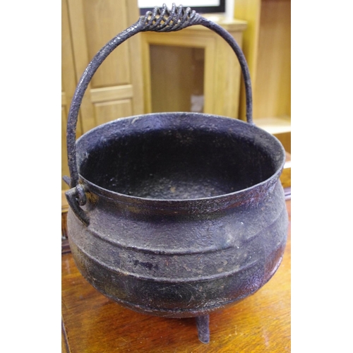 512 - A cast iron three legged cauldron circa 1900.