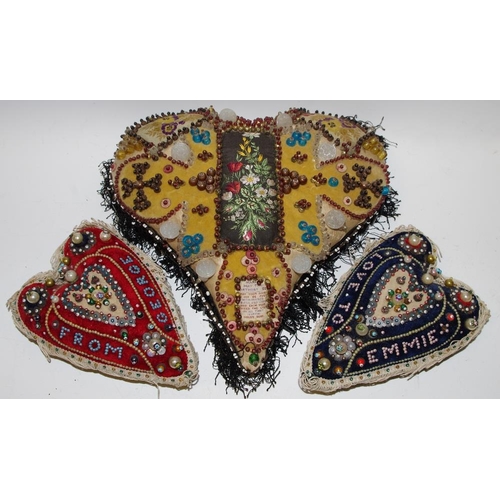 70 - Textiles - thee late Victorian/early 20th century novelty heart shaped pin cushions, jeweled and bea... 