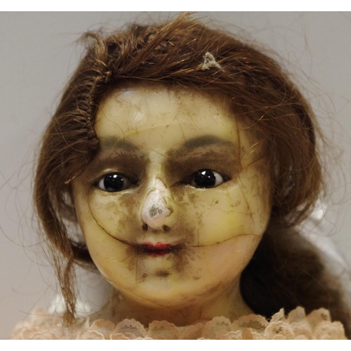 105 - A late 19th century wax and composite doll, wax head and limbs, brown glass eyes, long brown real ha... 