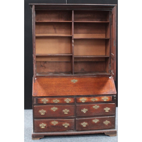 1 - An unusual and substantial mid-18th century oak bureau bookcase/cabinet, outswept cornice above a pa... 