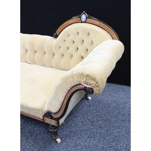 101 - A Victorian ebonised and parcel-gilt chaise longue/day bed, arched cresting rail centred by a Jasper... 