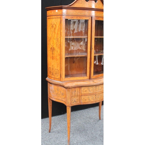 103 - A Sheraton Revival satinwood and marquetry serpentine display cabinet, break-arch pediment above a p... 