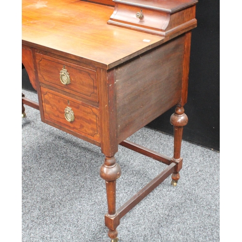 104 - An early 20th century mahogany dressing table, arched superstructure with adjustable mirror above tw... 