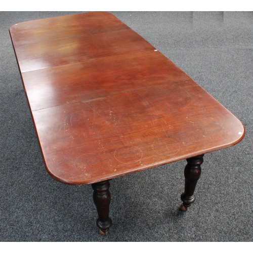 105 - A mahogany extending dining table, rounded rectangular top with two additional leaves, canon-barrel ... 