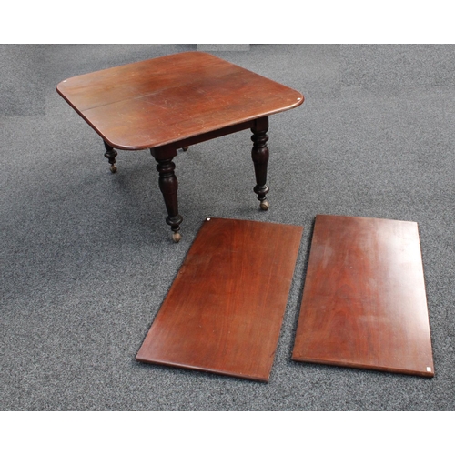 105 - A mahogany extending dining table, rounded rectangular top with two additional leaves, canon-barrel ... 