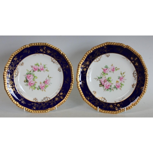 123 - A pair of Royal Crown Derby shaped circular plates, painted by Charles Harris, one signed CH, with w... 