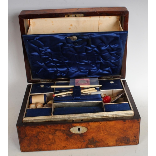 145 - A Victorian walnut rectangular work box, fitted interior enclosing a collection of conforming appurt... 