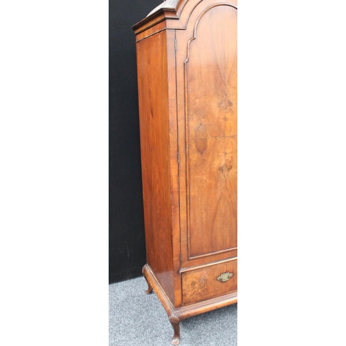 153 - A Queen Anne style walnut wardrobe, 'double-dome' cornice above a pair of doors enclosing a hanging ... 