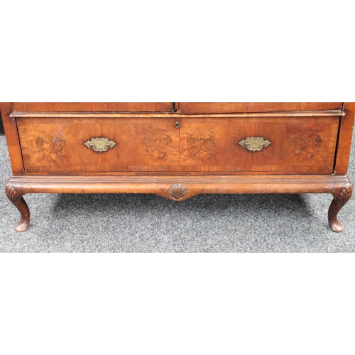 153 - A Queen Anne style walnut wardrobe, 'double-dome' cornice above a pair of doors enclosing a hanging ... 