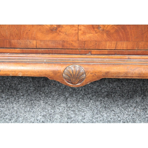153 - A Queen Anne style walnut wardrobe, 'double-dome' cornice above a pair of doors enclosing a hanging ... 
