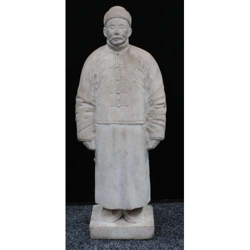 193 - A Chinese marble figure, carved as a man in a traditional tunic and fur hat, rectangular base, 57.5c... 