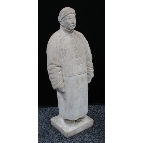 193 - A Chinese marble figure, carved as a man in a traditional tunic and fur hat, rectangular base, 57.5c... 